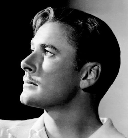 Image of Errol Flynn short hairstyle with thin mustache.