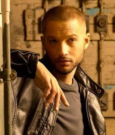 Picture of Logan Marshall Green short buzz haircut.