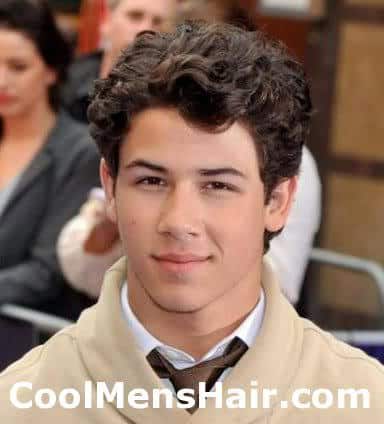Image of Nick Jonas layered curly hairstyle. 
