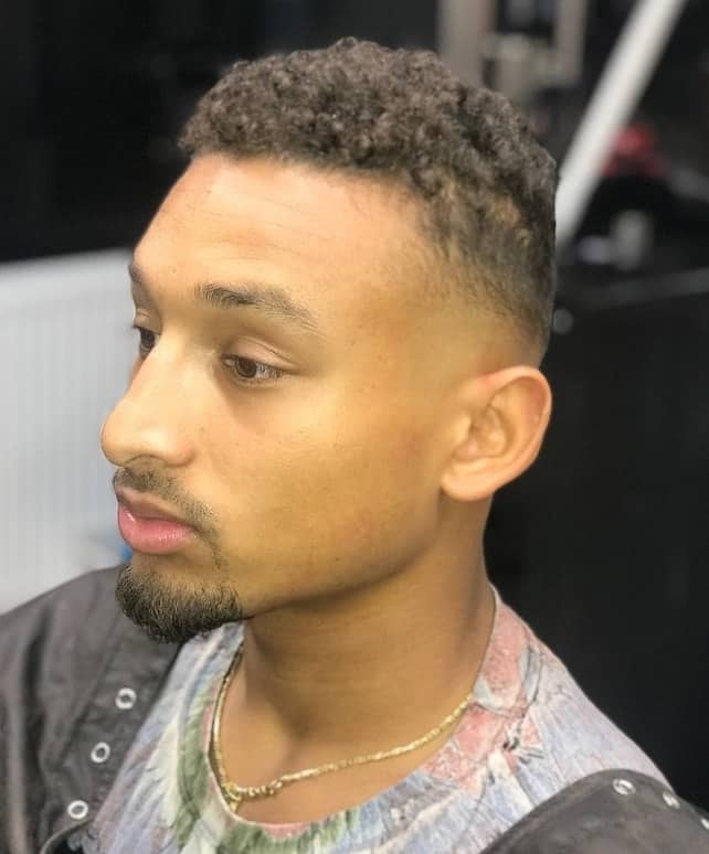 short curly hair with bald taper fade