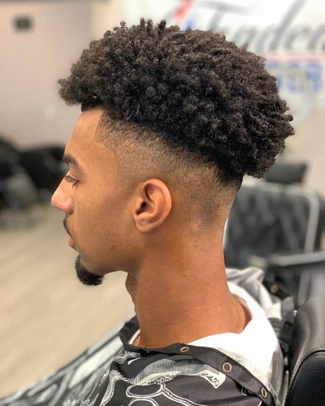 black guy with curly hair fade hairstyle