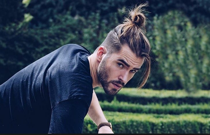 A picture of a hipster with a thick beard and a top knot hairstyle  Man  Bun Hairstyle