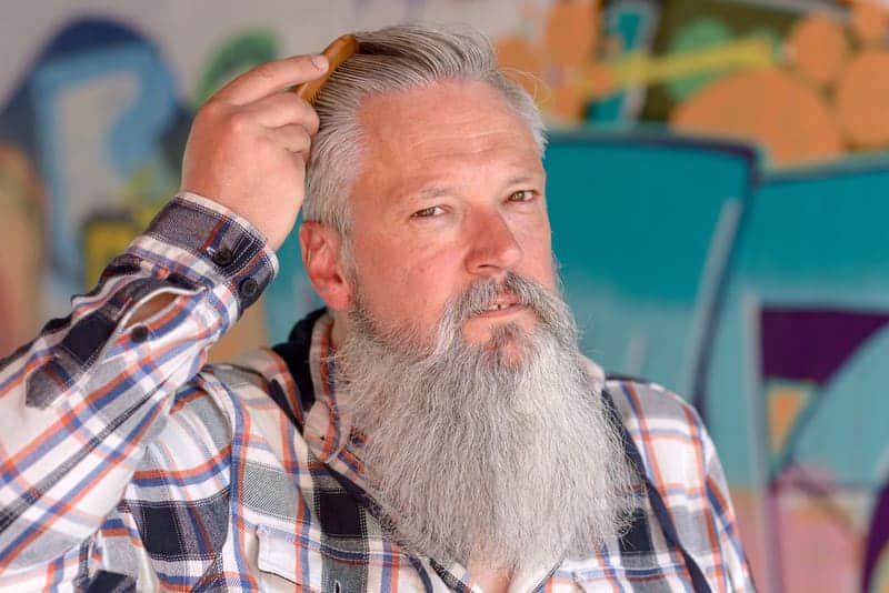 guy over 50 combing hair