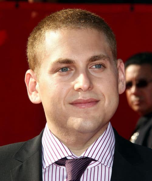 Photo of Jonah Hill buzz cut hairstyle.