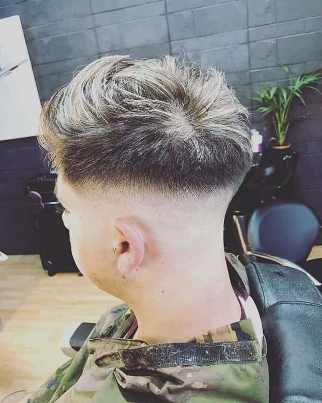 men's hairstyle with blonde tips and mid bald fade