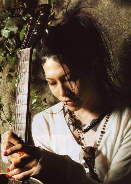 Photo of Miyavi ponytail hairstyle for guitarist.