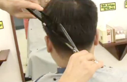 Photo of cutting hair using scissors-over-comb technique.