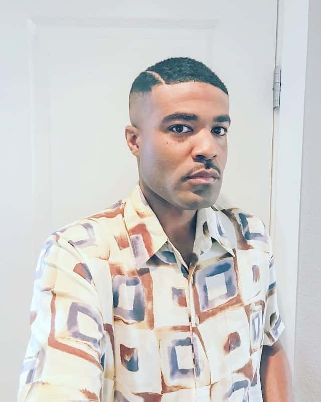black guy with short comb over hairstyle