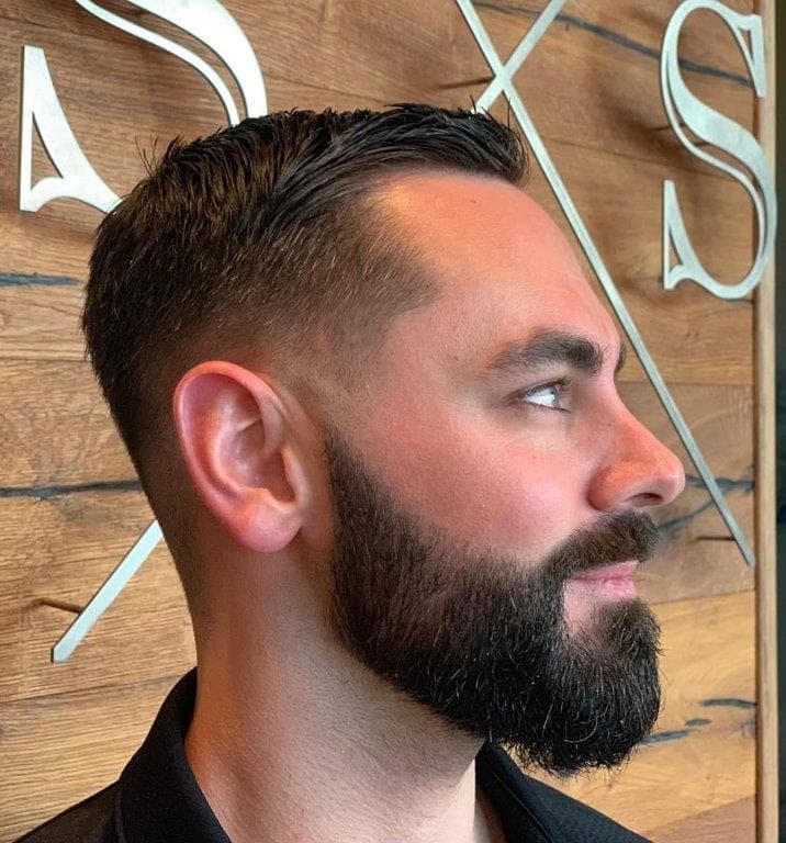 taper fade with side swept hair and beard