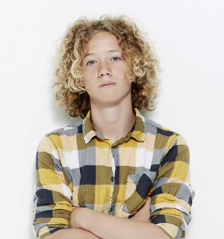 teen boy's long curly hair