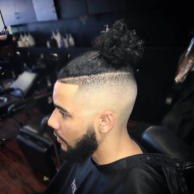 man with a bald fade top knot
