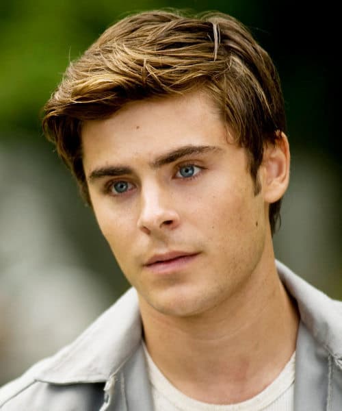 Photo of Zac Efron side parted hairstyle.